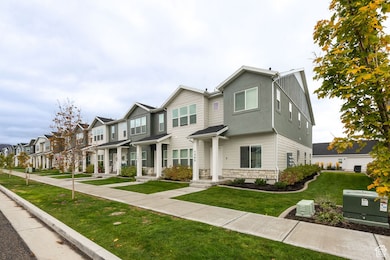 Traditional-style house featuring a front yard, stone siding, and a residential view
