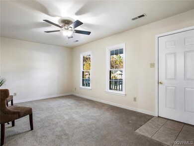 Carpeted foyer with ceiling fan