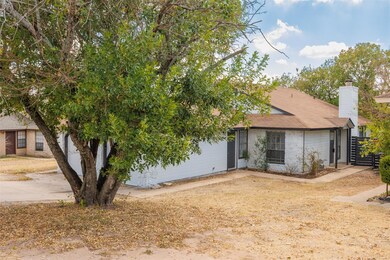 View of front facade with a chimney and a shingled roof