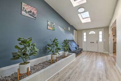 Entryway with baseboards, wood finished floors, an