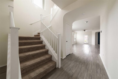 Staircase with a ceiling fan, visible vents, base