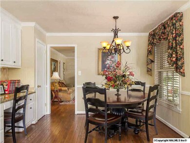 Eat-in kitchen with pantry, planning desk and hardwood floors opens to the family room.