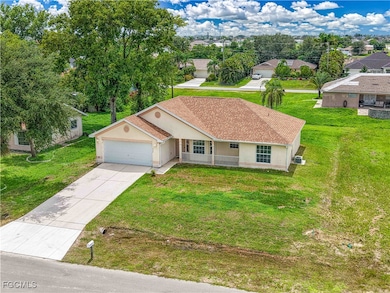 Ranch-style home with stucco siding, a garage, dri