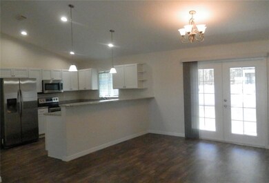 Granite counters with breakfast bar and pendant li