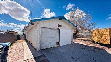 Detached garage with driveway and fence