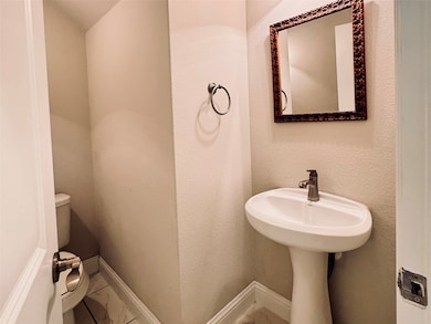 Half bath with a textured wall