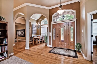 Grand entry with dramatic architectural features throughout. Beautiful light fixtures in every room.