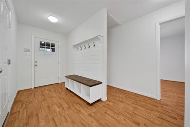 Entry with built in coat rack, seating & storage!