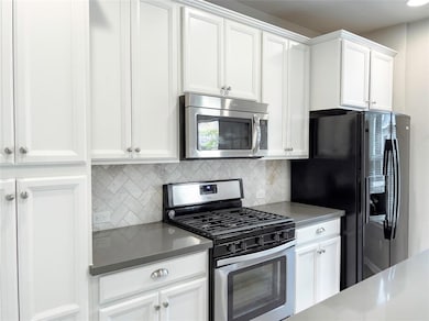 Kitchen with stainless steel appliances, tasteful