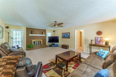 Light filled family room with Fireplace is perfect for cozy movie nights or watching the game in Surround Sound!