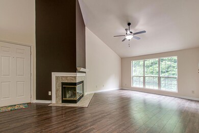 This renovated condo has the 'WOW' factor! This living area features a 14' vaulted ceiling, two-sided wood burning fireplace, ceiling fan and more!