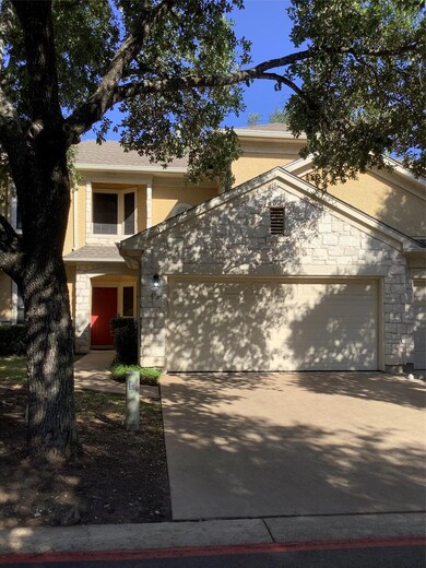 View of front of house featuring a garage, stone 