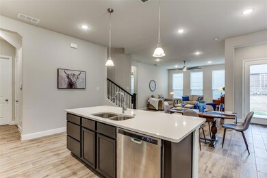 A large island with a stainless sink and canned li
