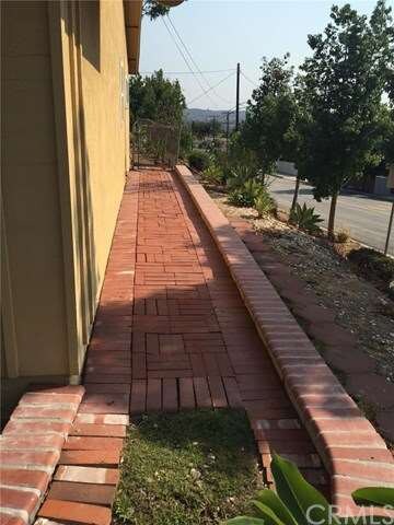 West side of home has a brick walkway.