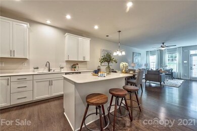 Bright white kitchen with island for prep space and additional seating.