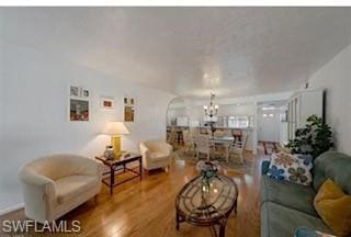 Living room with a chandelier and wood finished fl