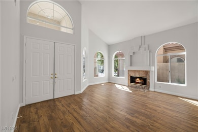 Foyer entrance with high vaulted ceiling, hardwood