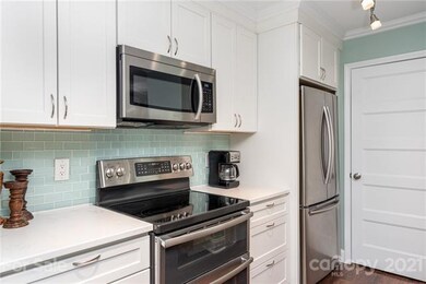 UPDATED KITCHEN WITH NEW DOOR TO LAUNDRY ROOM  FITTING FULL SIZE WASHER/DRYER