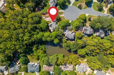 The lot is 1.87 acres and backs up to a creek and a neighborhood pond