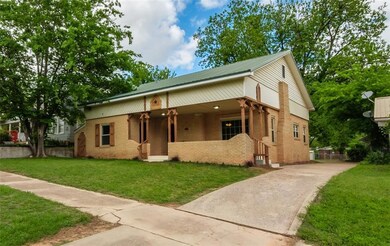 Doorway to property featuring brick siding