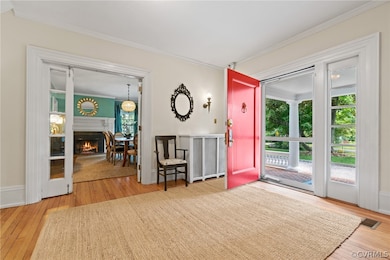 Gracious foyer with storm door, opening to formal rooms