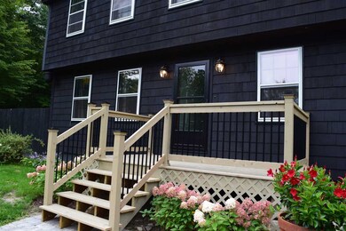 A brand new porch entry with granite steps and a n