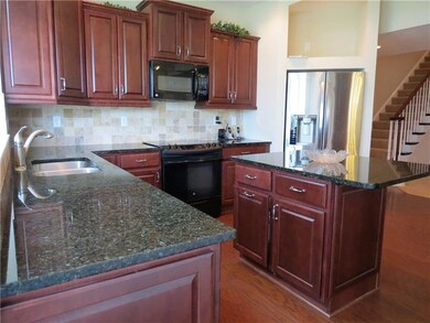 GRANITE COUNTER TOPS AND AN ABUNDANCE OF CABINETS 