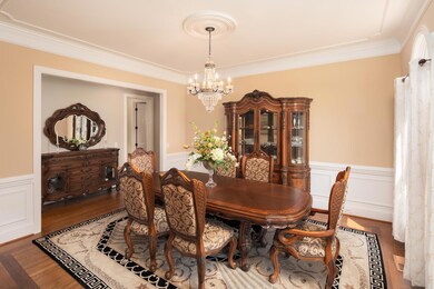 The formal dining room is just off the entrance foyer. Here you will find wainscoting, crown moulding, and a ceiling medallion. 