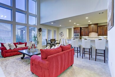 FAMILY ROOM (19 x 16)... Ceramic tile floors, soaring two story ceiling heights, wall of floor to ceiling windows allows for abundance of natural light and two inch blinds.