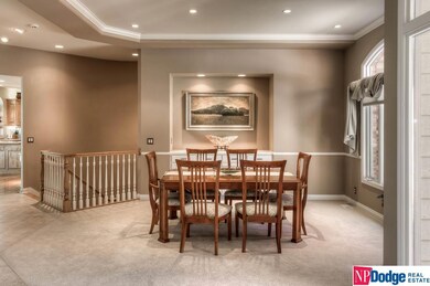 Dining Room has high vaulted ceiling with crown moldings, gorgeous arched window, and marble topped buffet.
