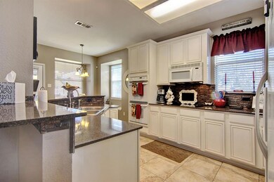 Light and bright cabinetry and updated backsplash!