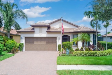 Front of the home is screened-in, bay windows in the front room, oversized 2+garage, tile roof, and lush landscaping