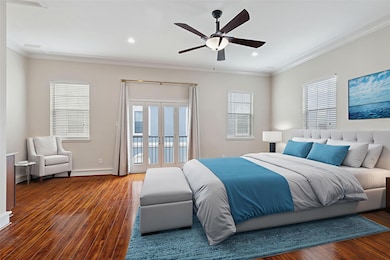 Bedroom with access to outside, wood finished floors, ornamental molding, recessed lighting, and a ceiling fan