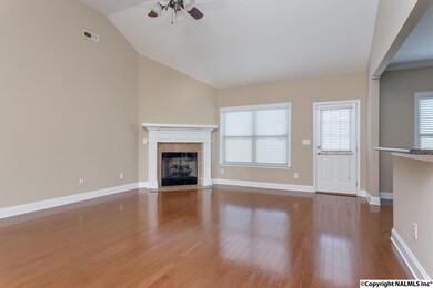 Great room with wood floors, and open to the Kitchen.