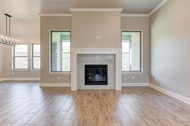 Unfurnished living room featuring crown molding, p