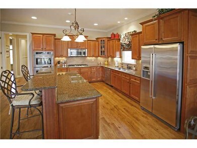 The kitchen features granite counter tops, stainle