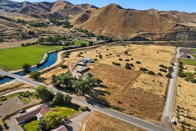 Aerial view of property and surrounding area featuring a water and mountain view and rural landscape