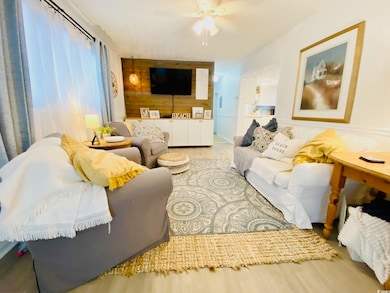 Living room featuring ceiling fan and light LVP fl