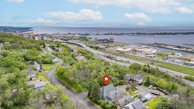 Birds eye view of property with a water view