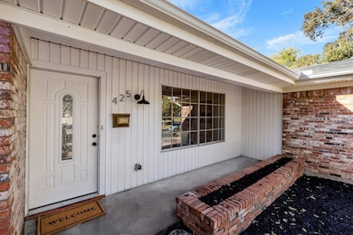 View of exterior entry with brick siding