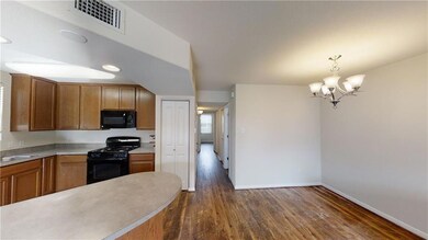 Kitchen with black appliances, light countertops,