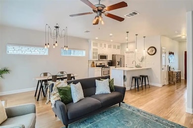 Living area with ceiling fan and light wood-style