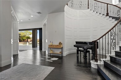 Entryway with dark wood finished floors, recessed