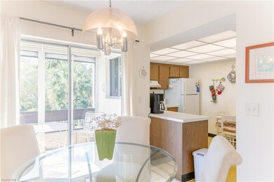 DINING AREA OVERLOOKING SCREENED PATIO AND KITCHEN
