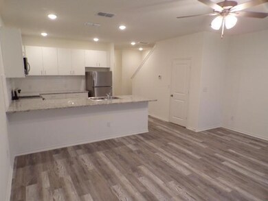 Kitchen featuring dark wood finished floors, white