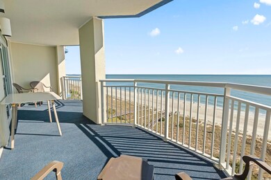 Balcony featuring a water view and a beach view