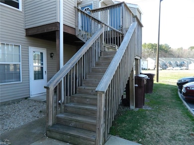 Back stairs to deck and unit entrance from parking