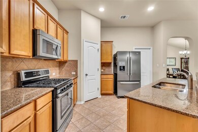 Kitchen with stainless steel appliances, arched w