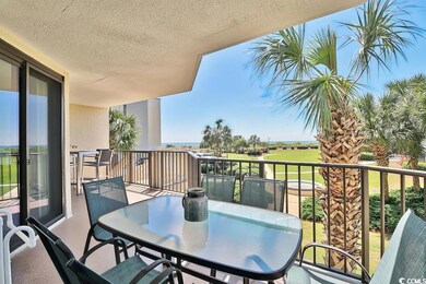 Balcony with view of golf course and outdoor dinin
