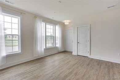 Empty room with a wealth of natural light and light hardwood / wood-style floors